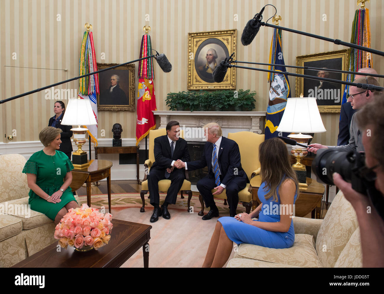 Washington DC, USA. 19th June, 2017. United States President Donald J. Trump shakes hands with President Juan Carlos Varela of Panama in the Oval Office of the White House in Washington, DC on June 19, 2017. Also seated are Lorena Castillo, left, and first lady Melanie Trump, right. Credit: Molly Riley/CNP /MediaPunch/Alamy Live News Stock Photo