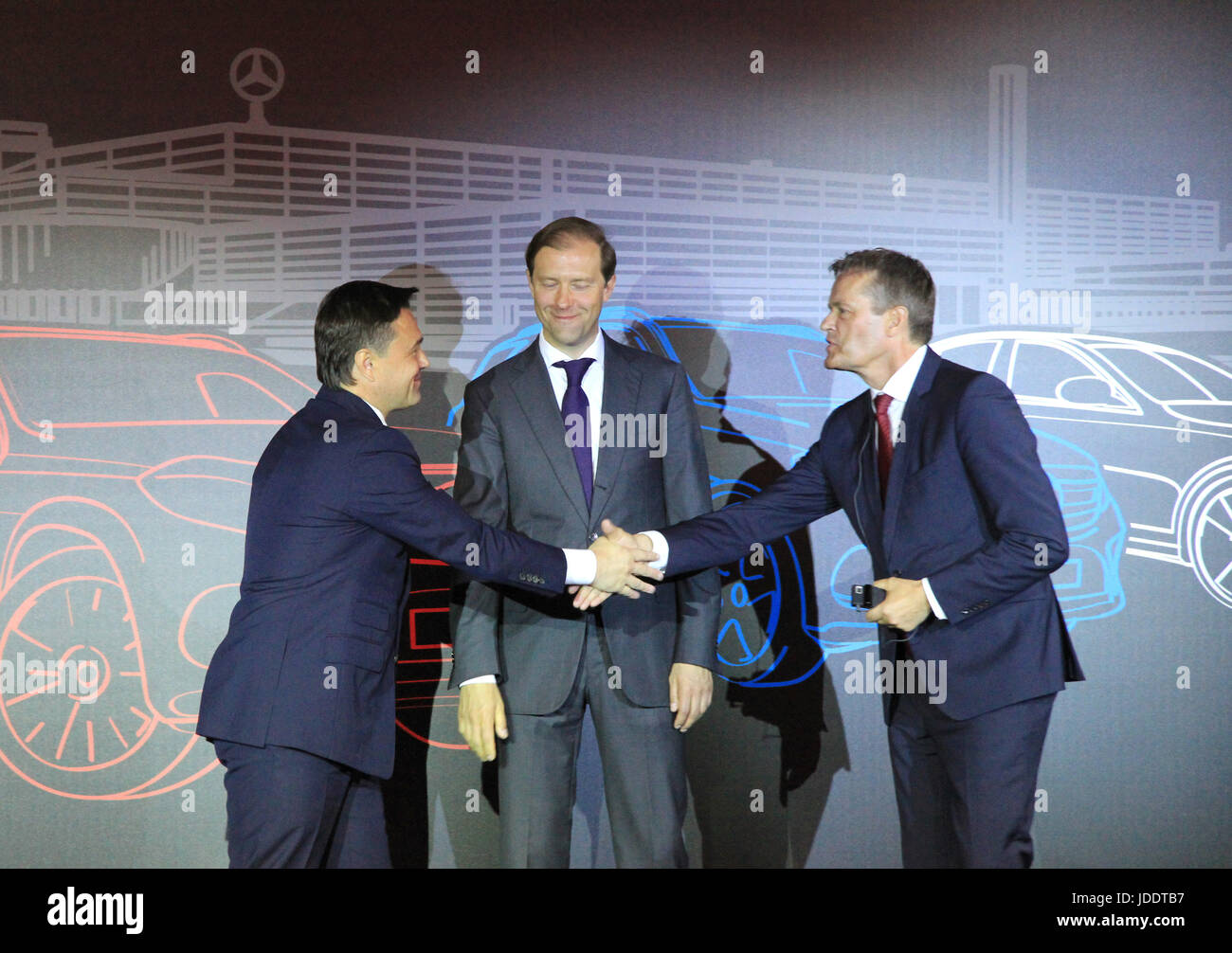 Andrey Vorobyov (left to right), governor of the Moscow district, Denis Manturov, Russia's Minister for Industry, and Markus Schafer, from Mercedes-Benz Cars, shake hands at the Yesipovo Industrial Part northwest of Moscow, Russia, 20 June 2017. The auto manufacturer from Stuttgart, Daimler, has recently embarked on the construction of its first plant in Russia. Representatives from Daimler laid down the foundation stone for the new plant in the presence of the Russian Minister for Industry, Manturov. Photo: Thomas Körbel/dpa Stock Photo