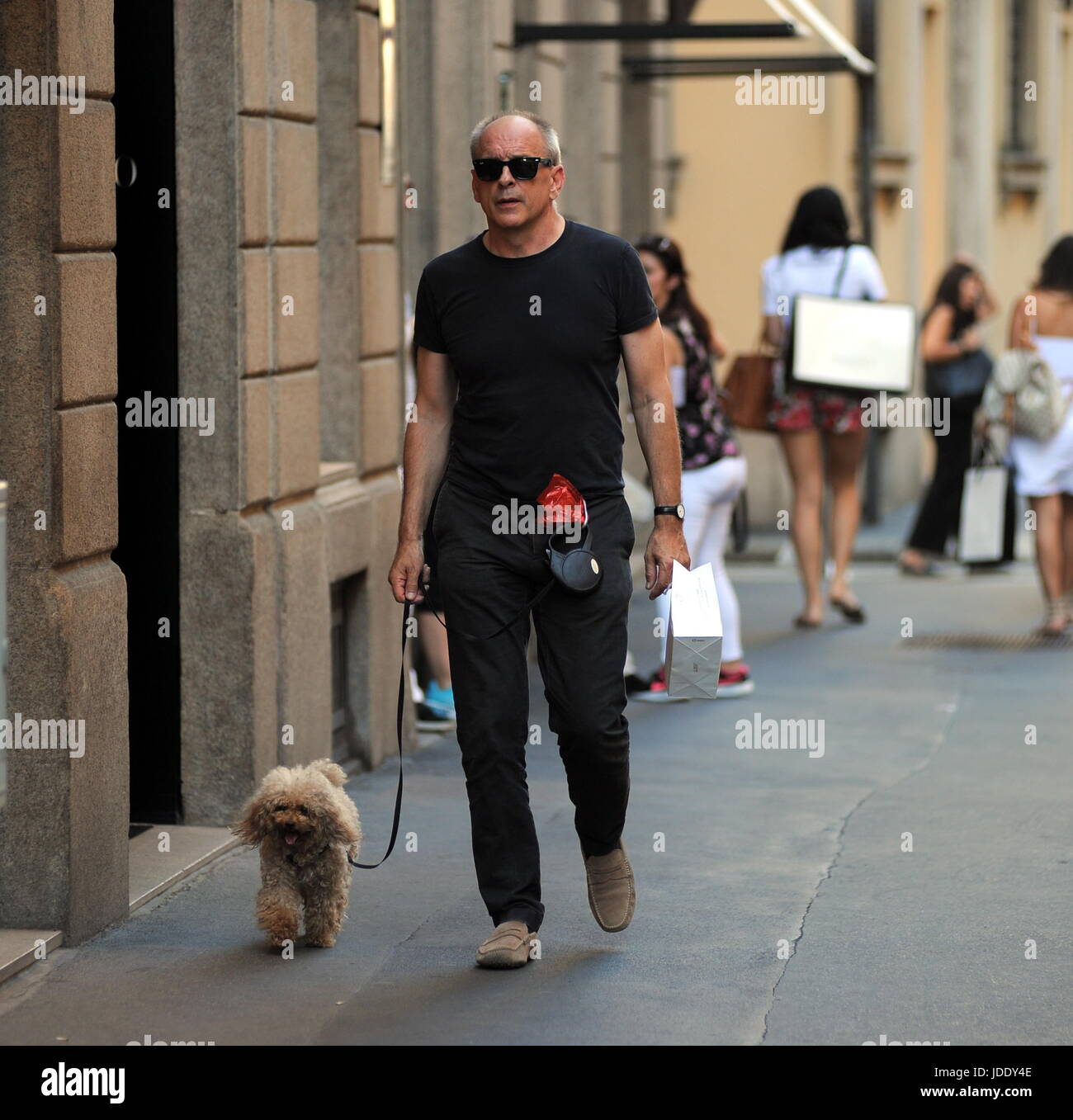 Milan, Tomas Arana Walking His Dog The famous American actor TOMAS ARANA, engaged with Silvia Damiani, owner, together with the brothers Guido and Giorgio of the famous brand of 'DAMIANI' jewels, walks alone in the center. Here, in Montenapoleone on a very hot afternoon, with a pair of black glasses for not knowing if you bring your dog for a short walk. Stock Photo