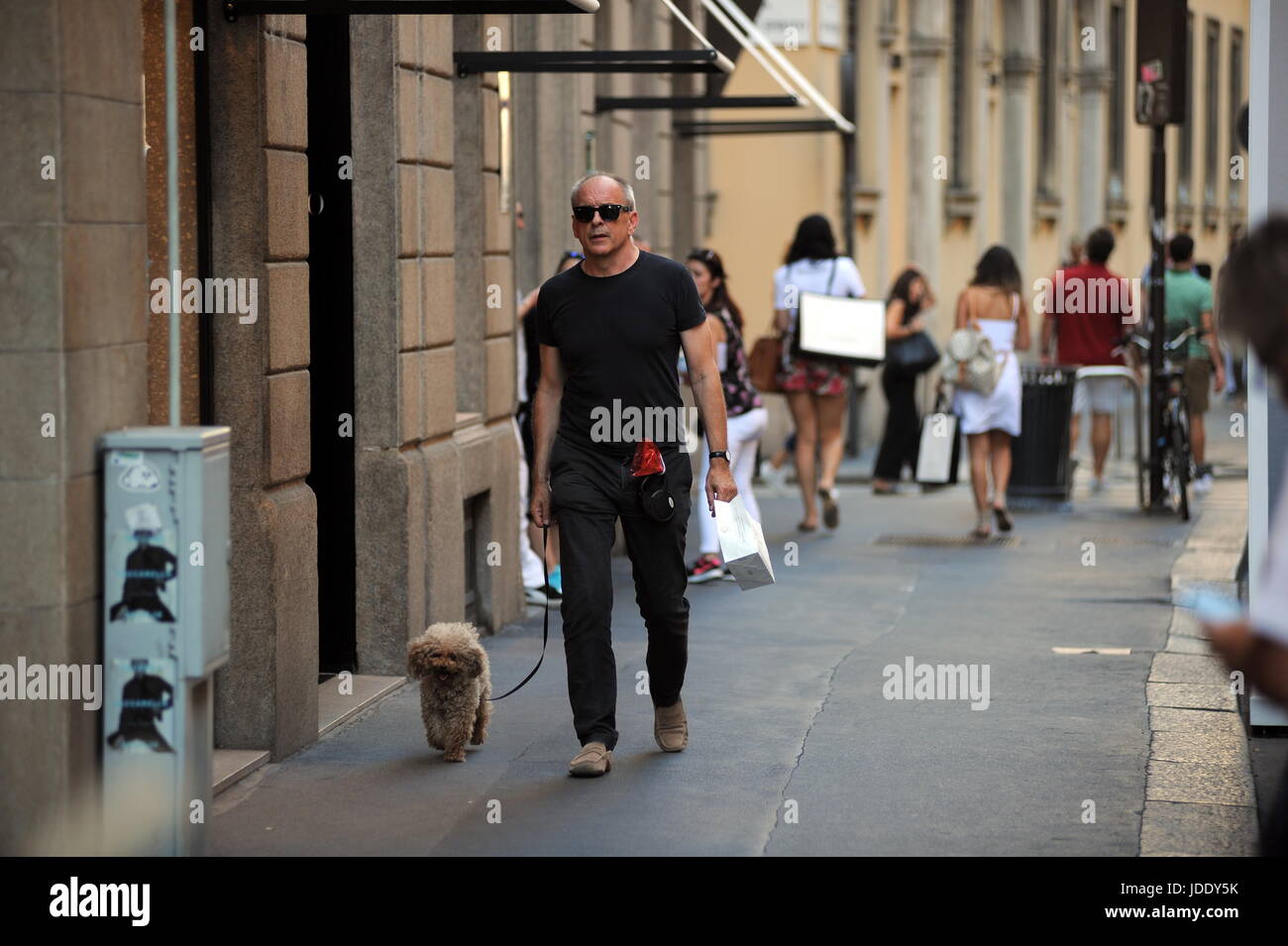 Milan, Tomas Arana Walking His Dog The famous American actor TOMAS ARANA, engaged with Silvia Damiani, owner, together with the brothers Guido and Giorgio of the famous brand of 'DAMIANI' jewels, walks alone in the center. Here, in Montenapoleone on a very hot afternoon, with a pair of black glasses for not knowing if you bring your dog for a short walk. Stock Photo