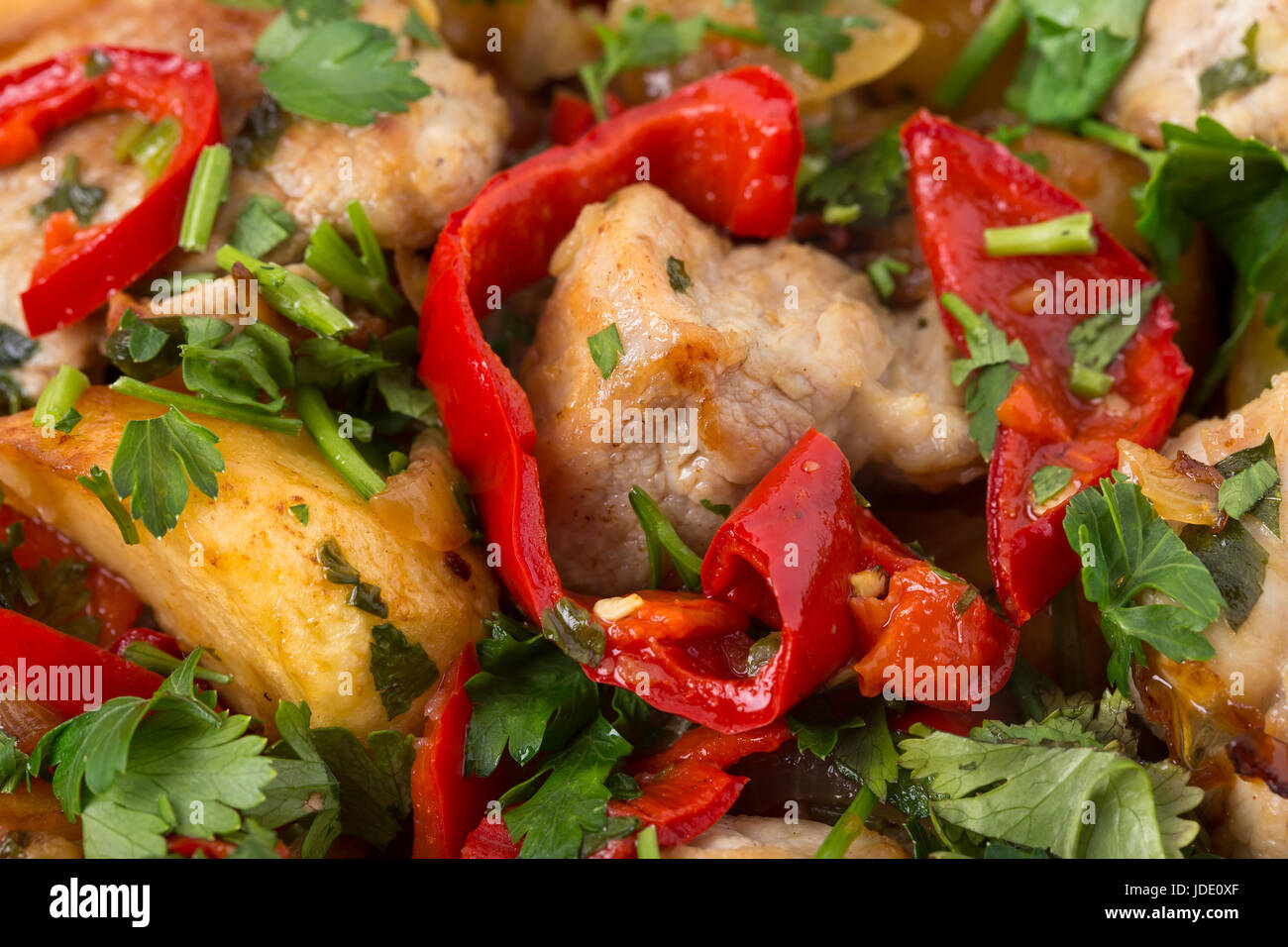 Roast pork fillets with potatoes and paprika. Macro. Photo can be used as a whole background. Stock Photo