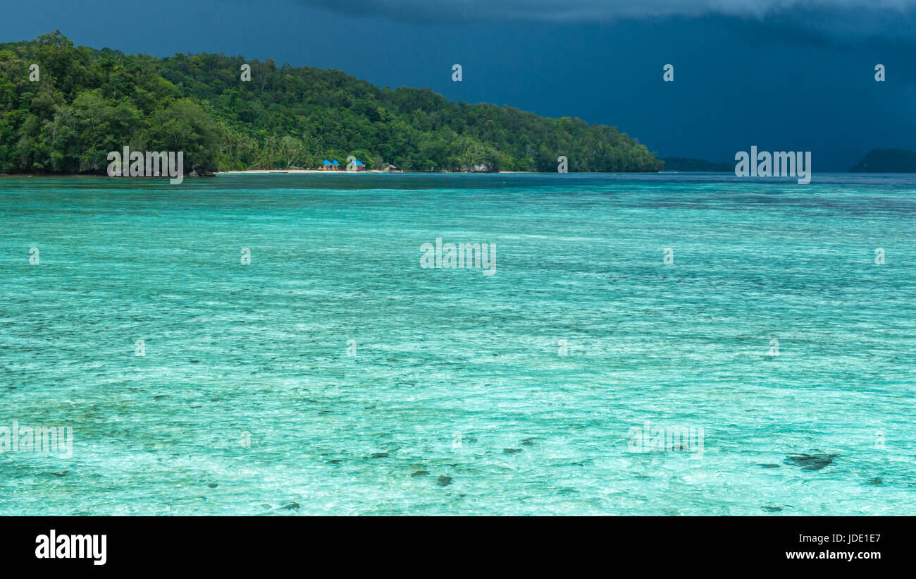 Beautiful Blue Lagoone shortly before Thunderstorm, near Kordiris Homestay, Gam Island, West Papuan, Raja Ampat, Indonesia. Stock Photo