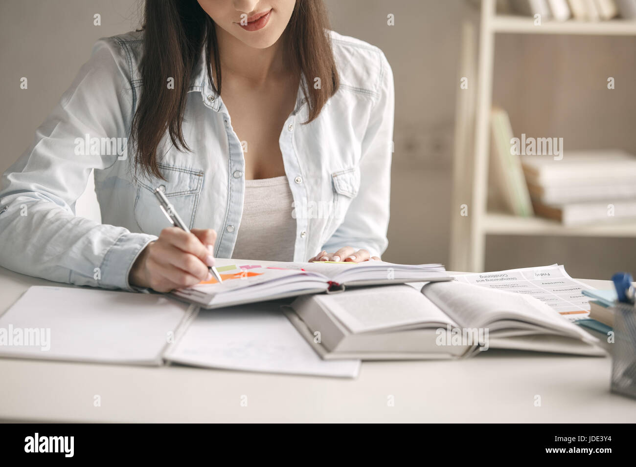 Young woman study at home alone taking notes Stock Photo - Alamy