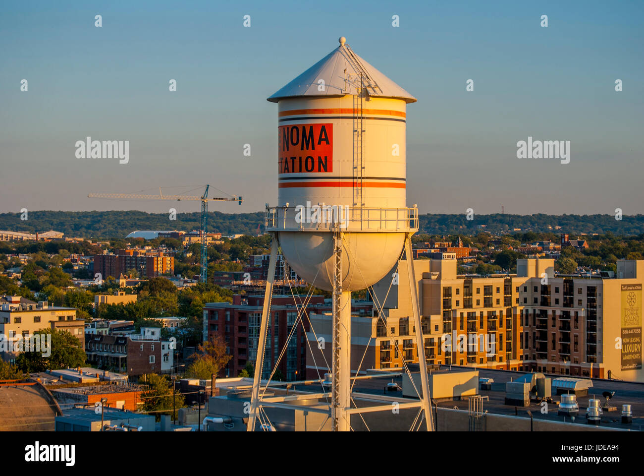 Water towers, and buildings in Washington DC in the warm glow of sunset