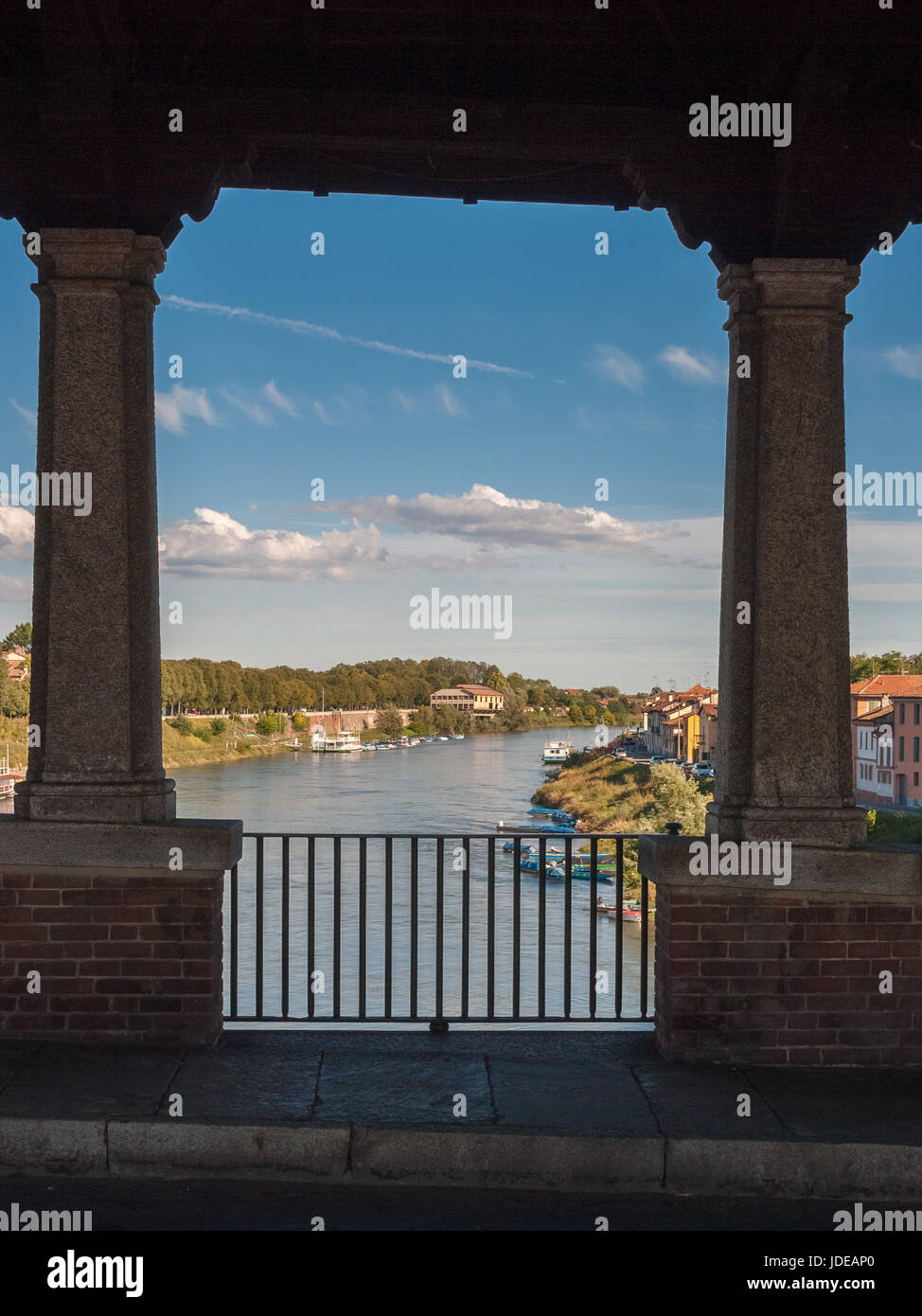 Glimpse of river Ticino in Pavia through the openings of Ponte Coperto Stock Photo