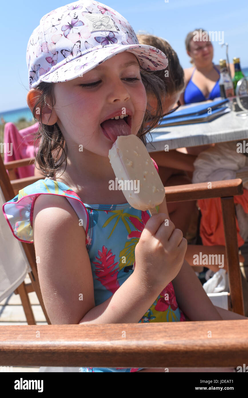 Girl licking ice cream on summer holiday Stock Photo