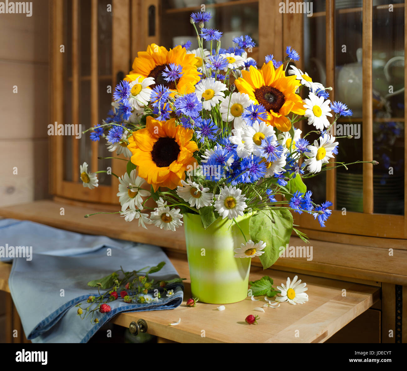 Bouquet of flowers with sunflowers, cornflowers and daisies. Stock Photo