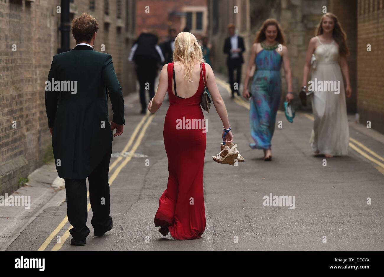 Students make their way home after attending a May Ball at Cambridge University which is the traditional celebration to mark the end of the academic year. Stock Photo