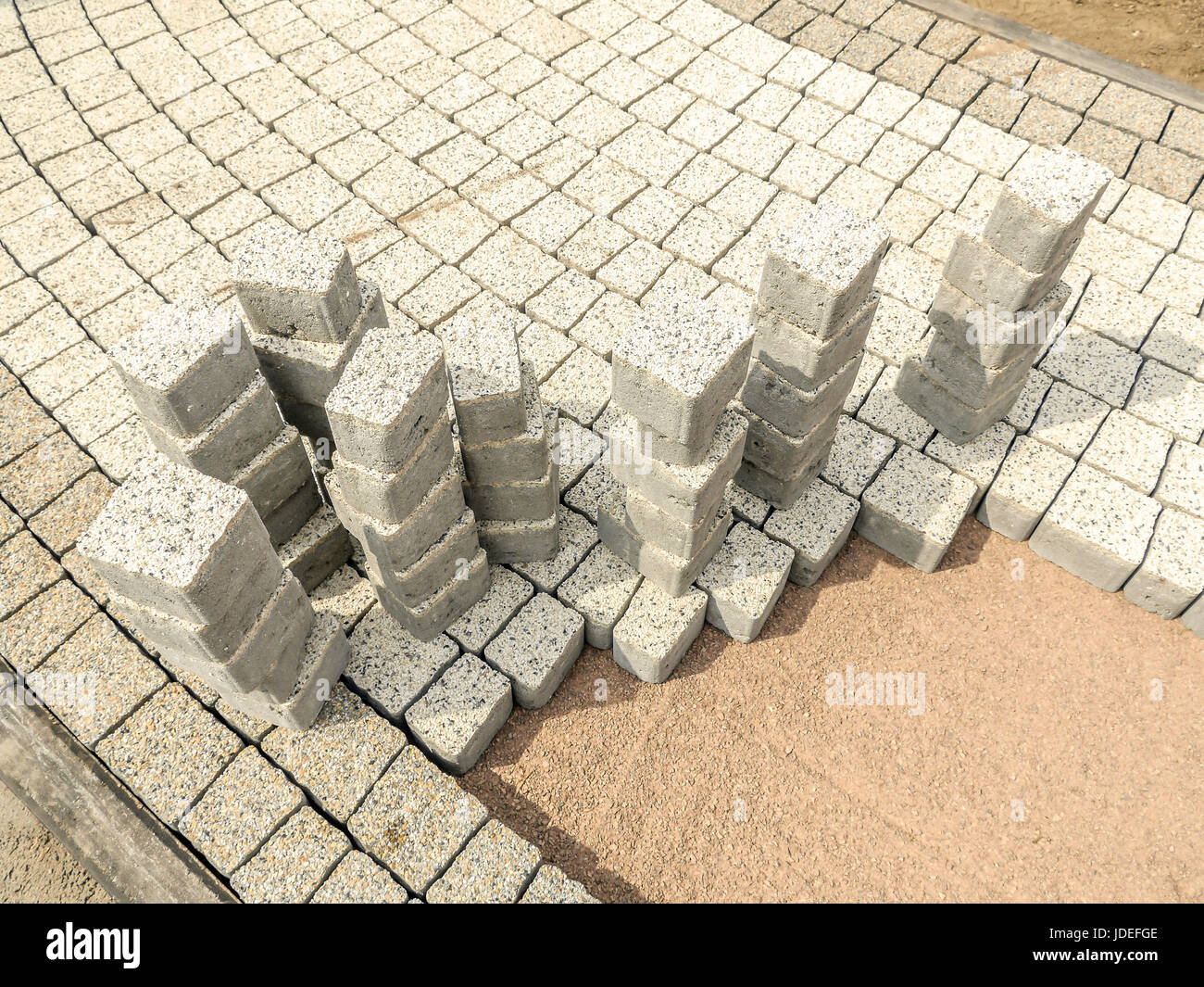 Closeup of unfinished pavement path with set of concrete pavement blocks Stock Photo