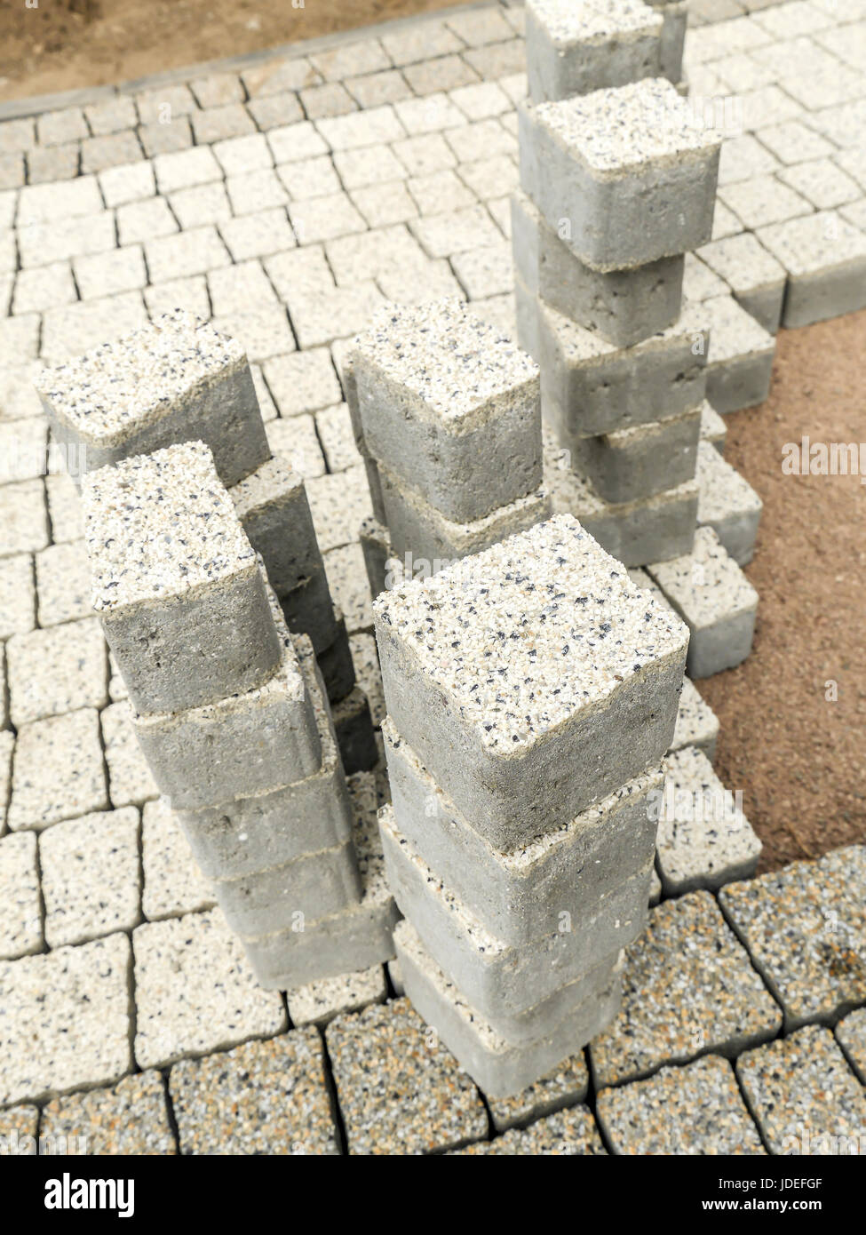 Closeup of unfinished pavement path with set of concrete pavement blocks Stock Photo