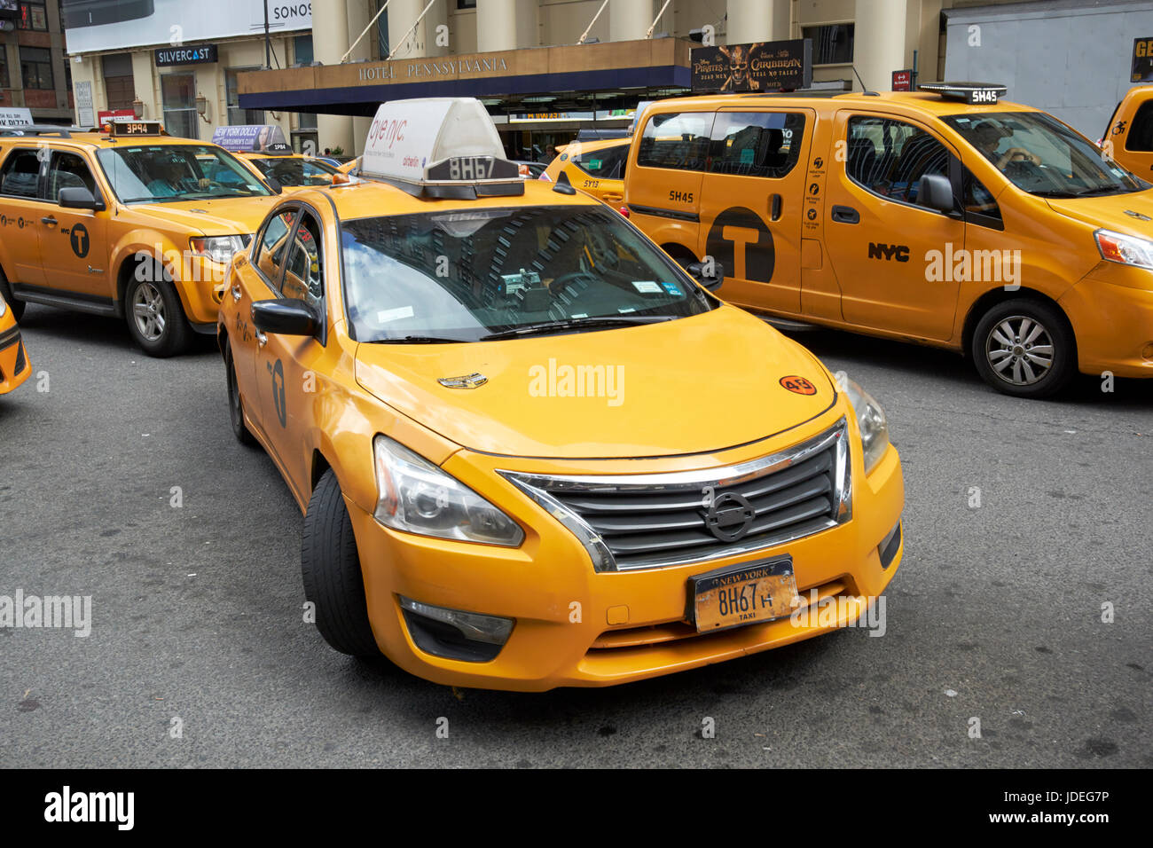 yellow cabs on 7th avenue with one pulling in to curb New York City USA Stock Photo