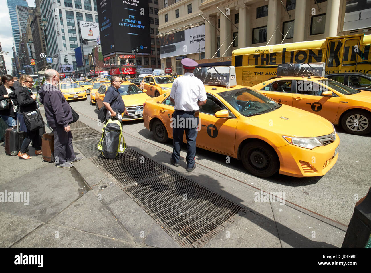 people waiting at yellow cabs stop at taxi rank on 7th avenue outside penn station New York City USA Stock Photo
