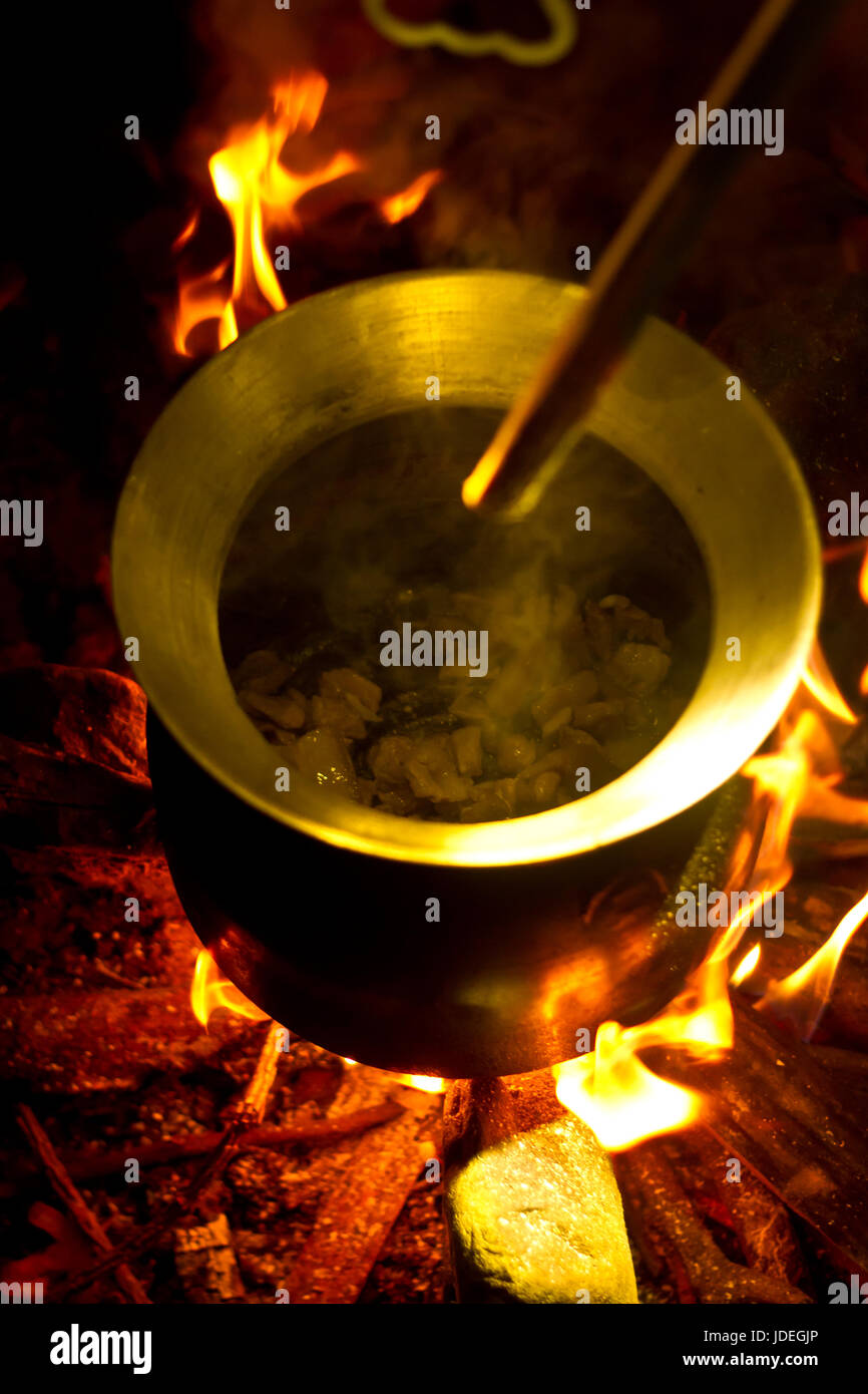 Cooking in a pot over campfire on a hike in the jungle of cambodia ...