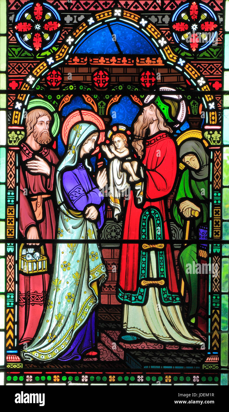 Presentation in The Temple, of baby Jesus, by Mary and Joseph, stained glass window by Frederick Preedy, 1865, Gunthorpe, Norfolk, England, UK Stock Photo