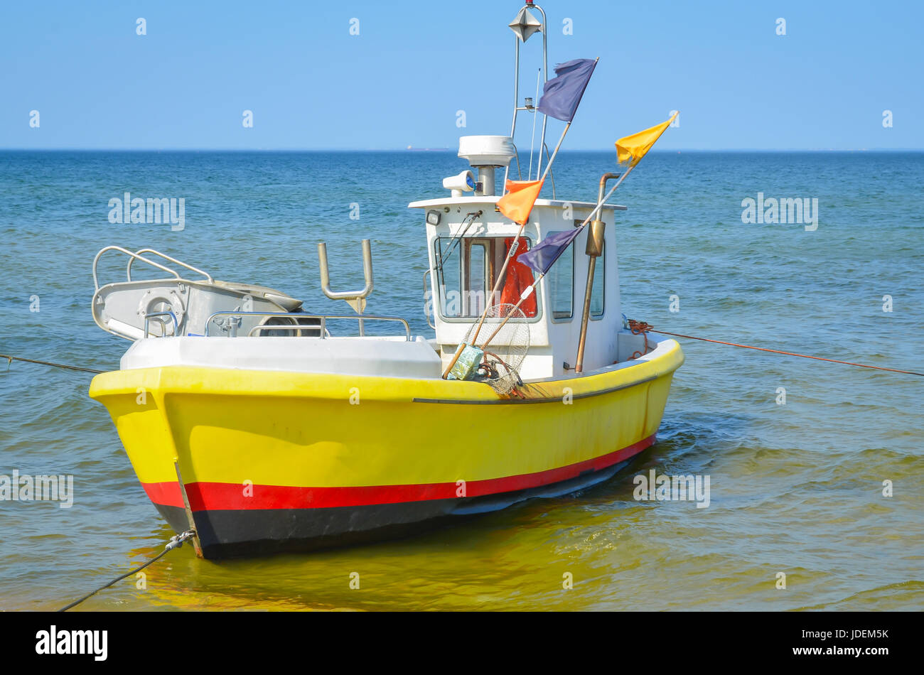 White yellow  fishing boat on alongshore Stock Photo