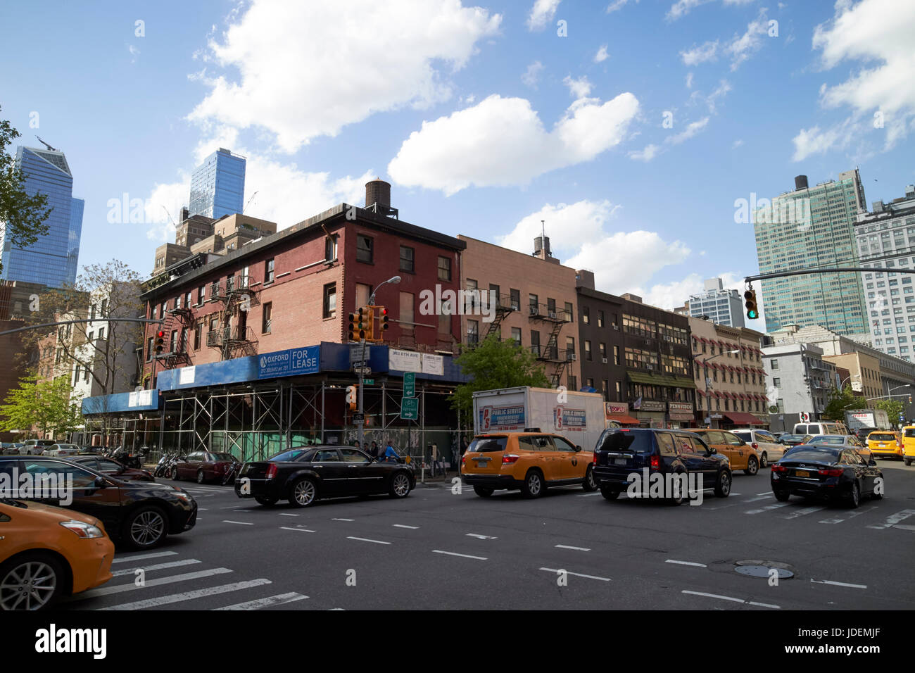 low rise commercial buildings and stores on 8th avenue chelsea New York City USA Stock Photo