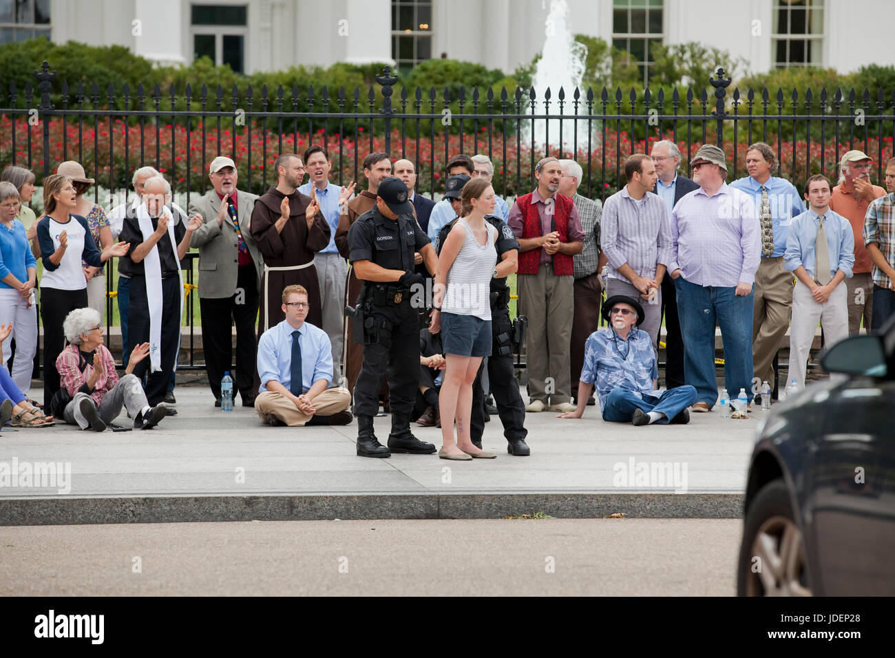 Female environmental activists and protesters arrested for civil disobedience in front of White House (woman arrested, detained) - Washington, DC USA Stock Photo