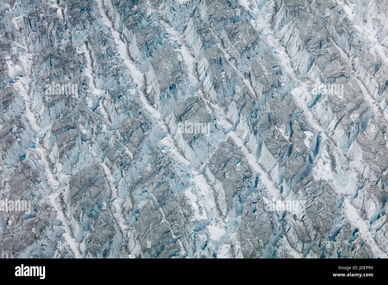 Abstract pattern of white and blue ice in glacier ravines Stock Photo