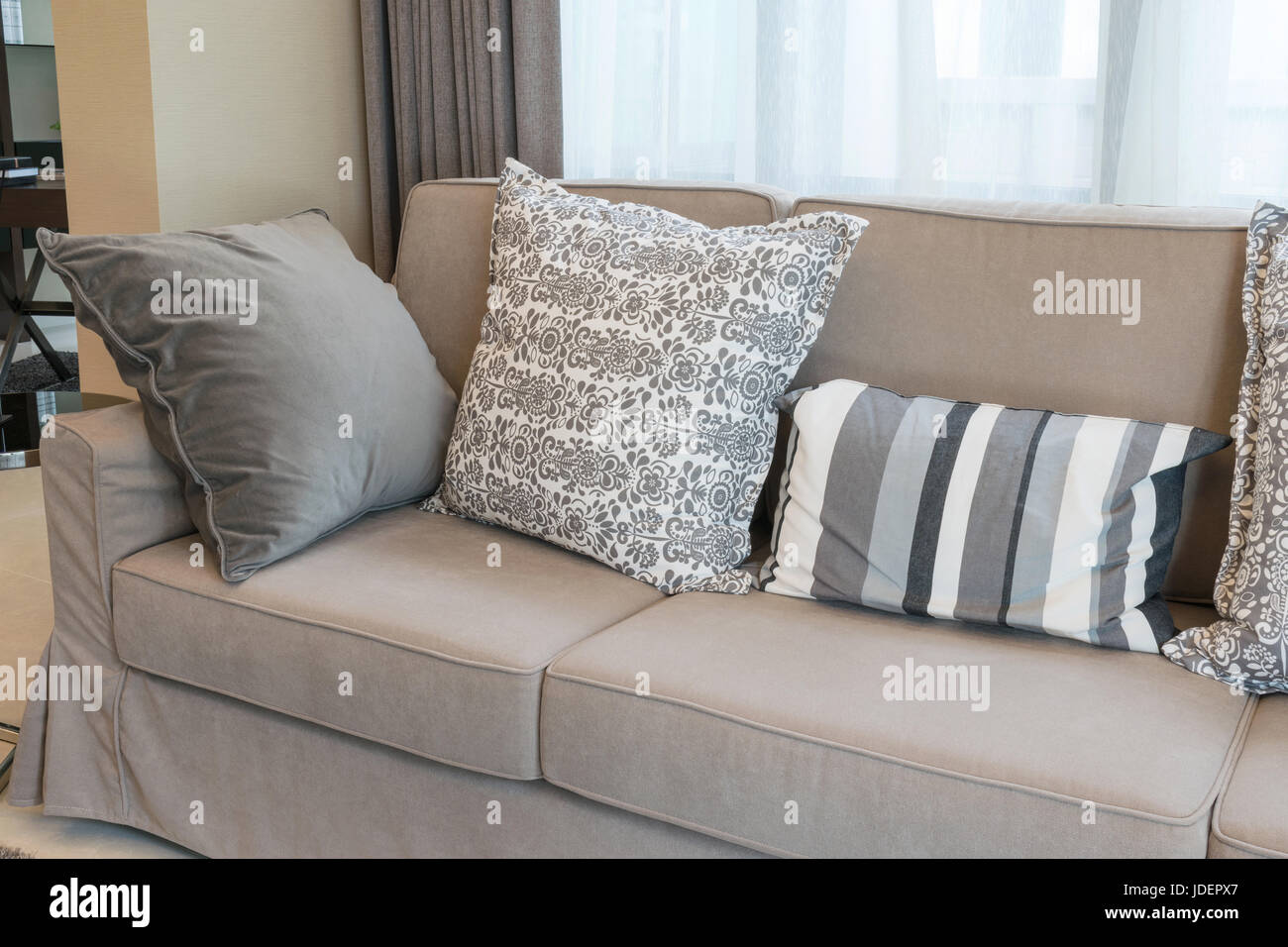 Sy Brown Tweed Sofa With Grey Patterned Pillows Stock