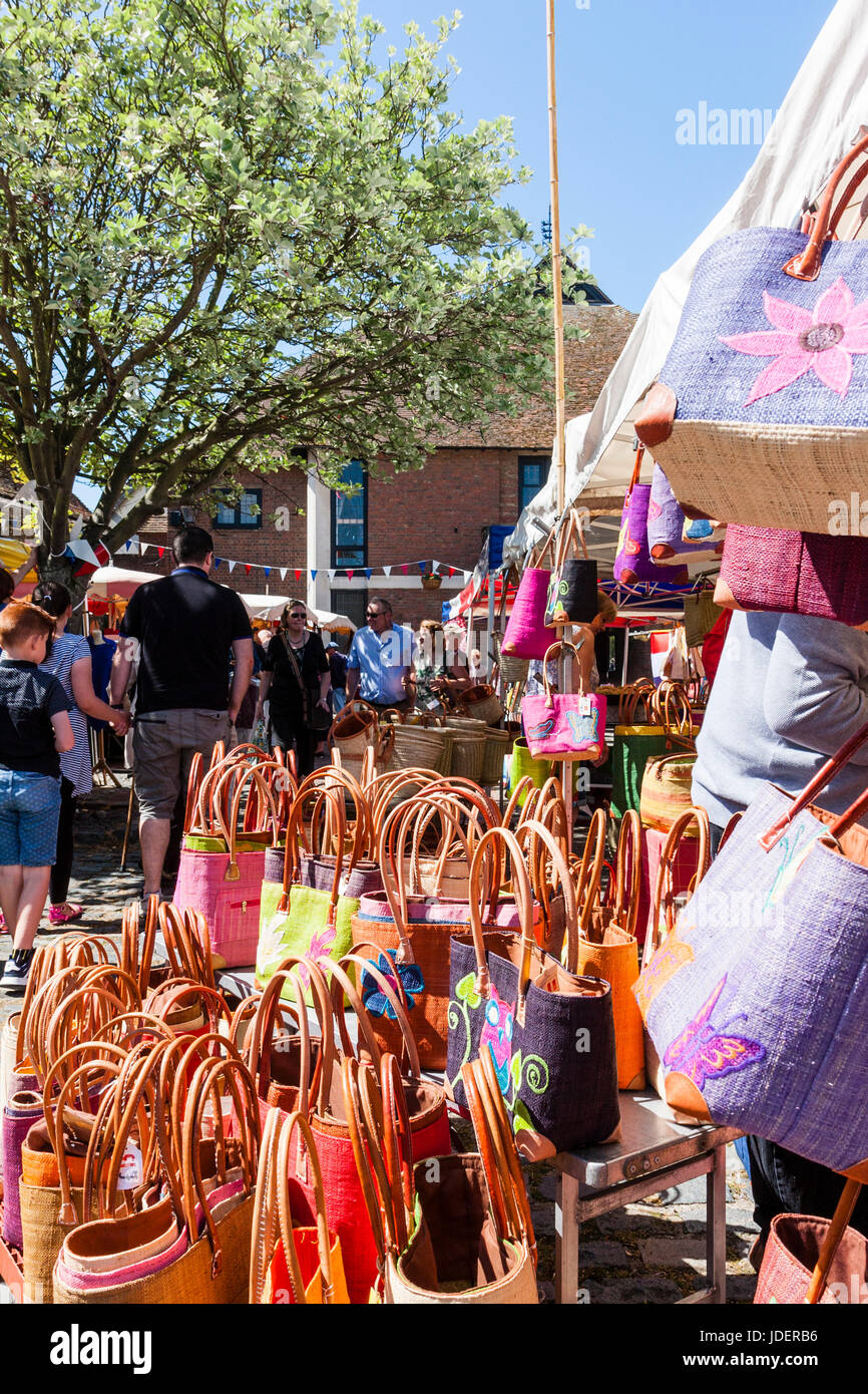 French Market stall selling traditional handbags, shopping bags and purses, set up at Sandwich town, England as part of event. Bright sunshine. Stock Photo