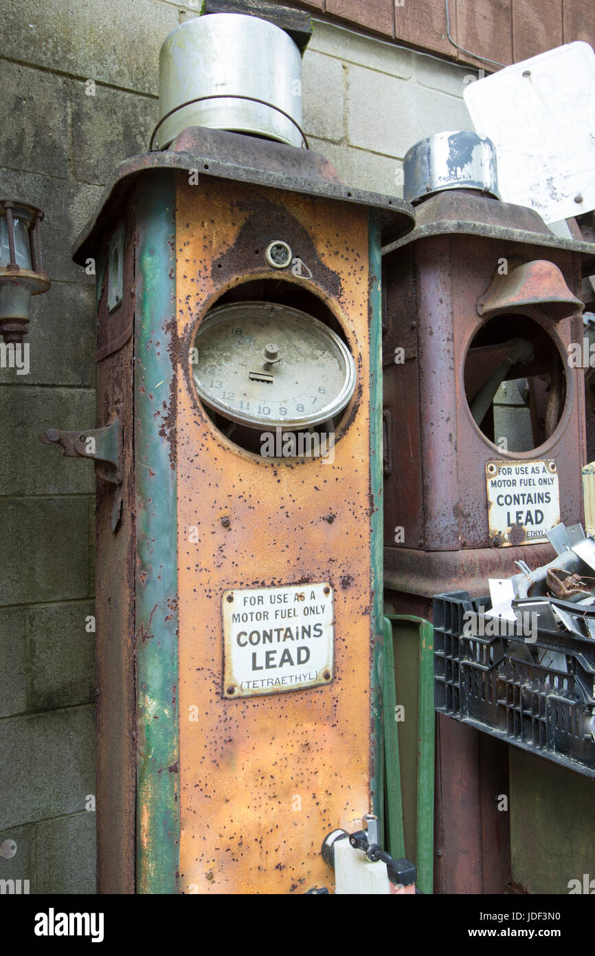 Vintage gasoline pumps rusting in junkyard Stock Photo Alamy