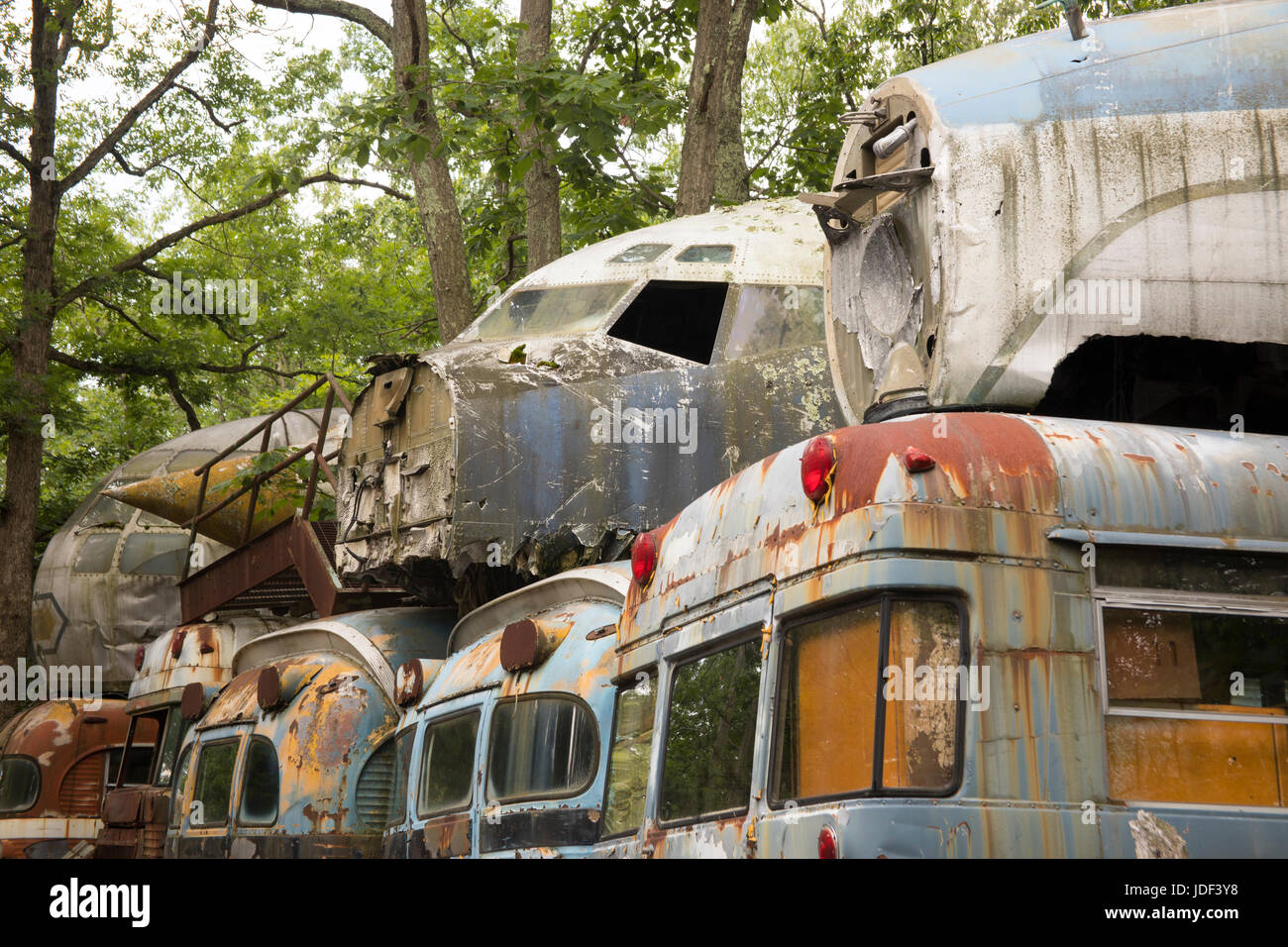 Cockpit units of wrecked military aircraft on top of transport busses in junkyard. Stock Photo