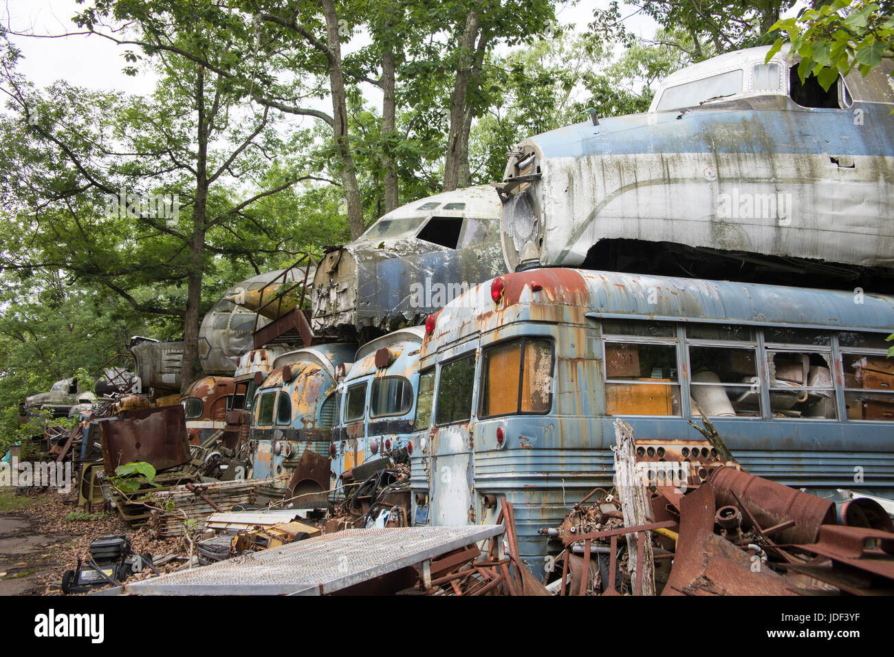 Cockpit units of wrecked military aircraft on top of transport busses in junkyard. Stock Photo