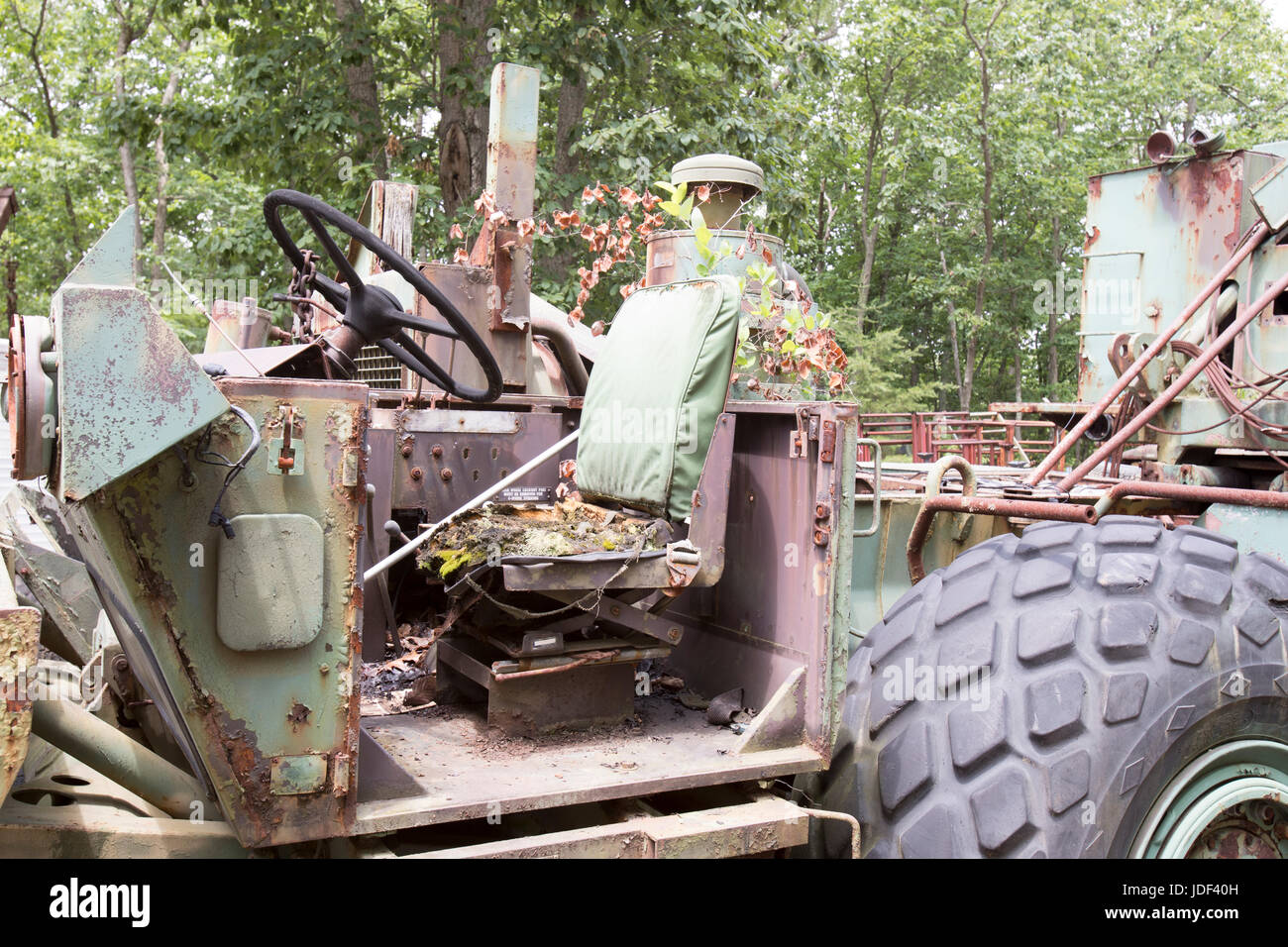 Idle heavy construction equipment rusting in field of junkyard Stock