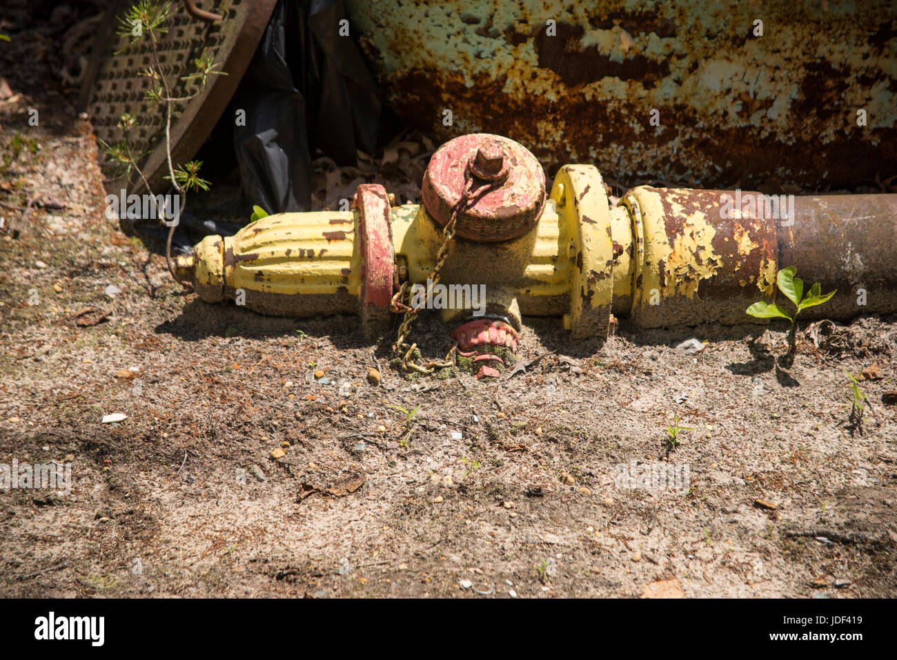 Fire hydrant partially buried in ground. Stock Photo
