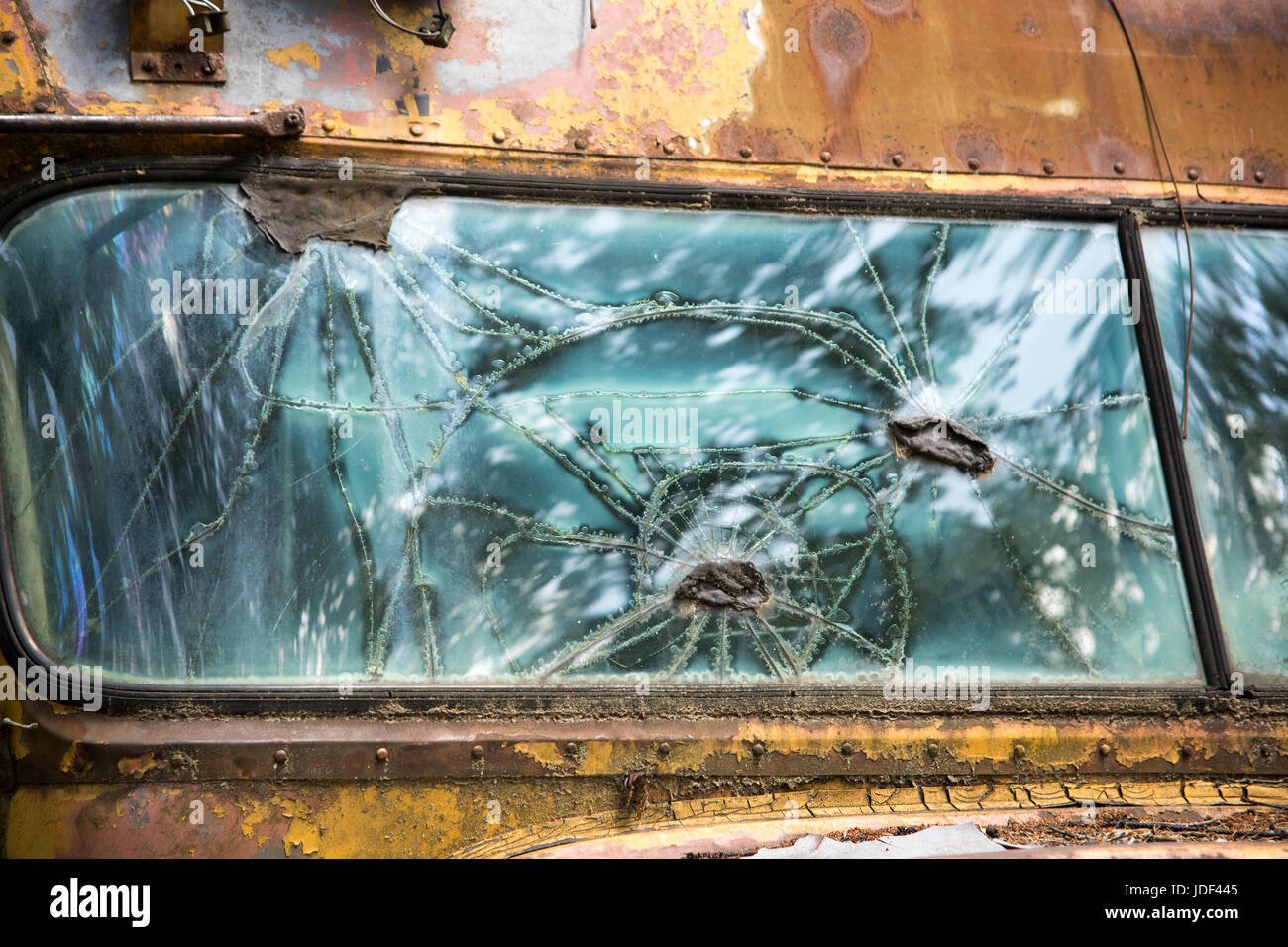 Abstract patterns in broken window of rusty old school bus Stock Photo ...