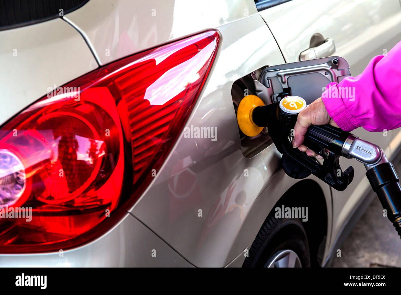 Woman filling her car with fuel at petrol station Stock Photo