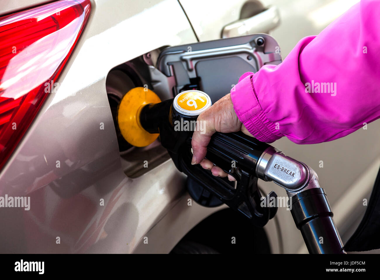 Woman filling her car with fuel at petrol station Stock Photo