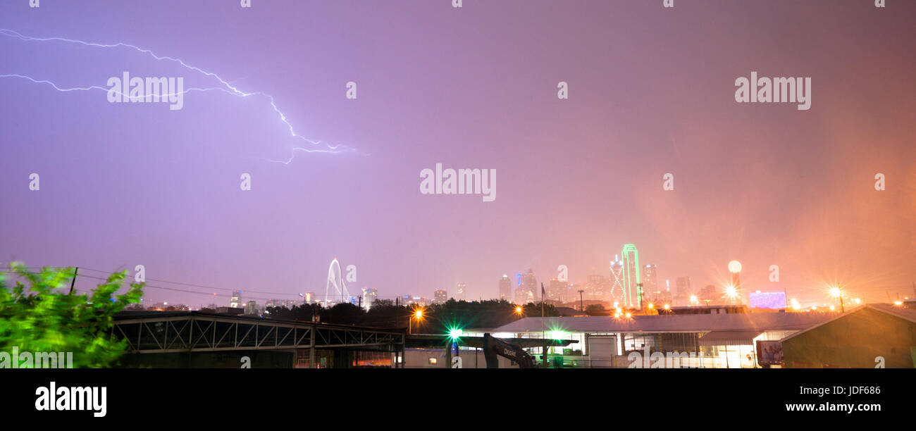 The sky is lit up purple over Dallas during a summer thunderstorm Stock Photo