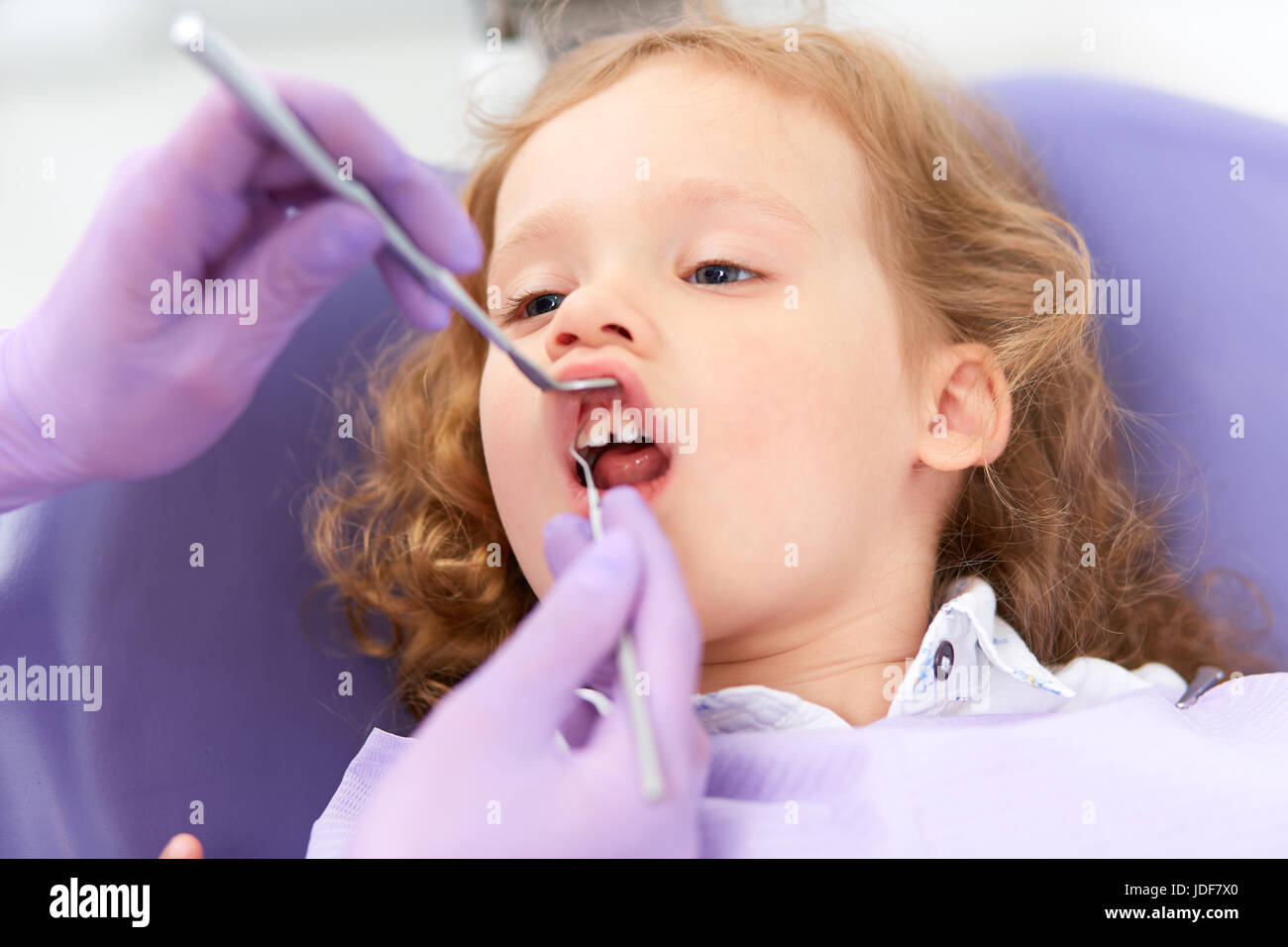 Dentist examining under lip Stock Photo Alamy
