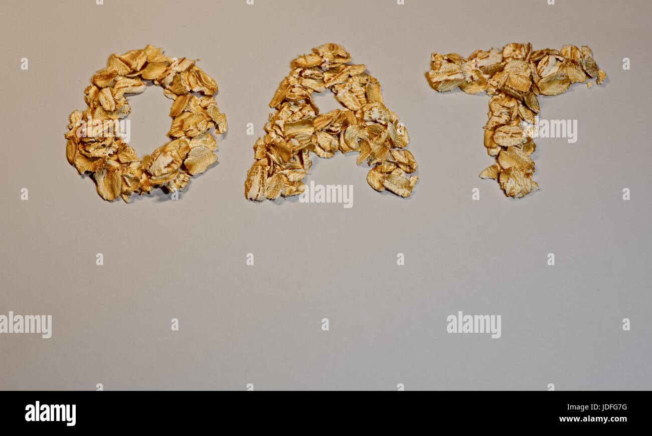 The word OAT written with oat flakes on white background Stock Photo