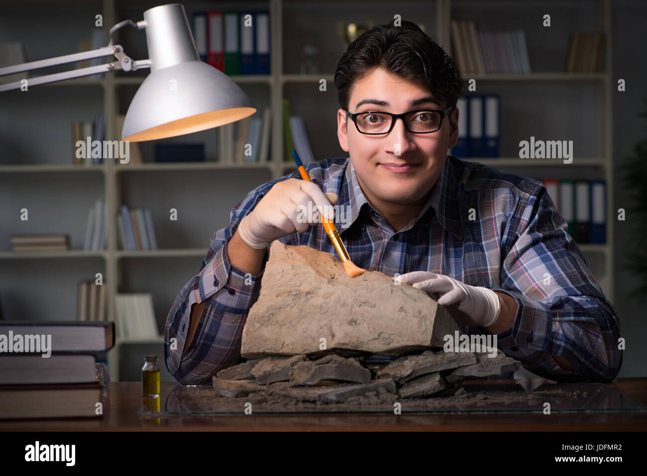 Archeologist working late night in office Stock Photo Alamy