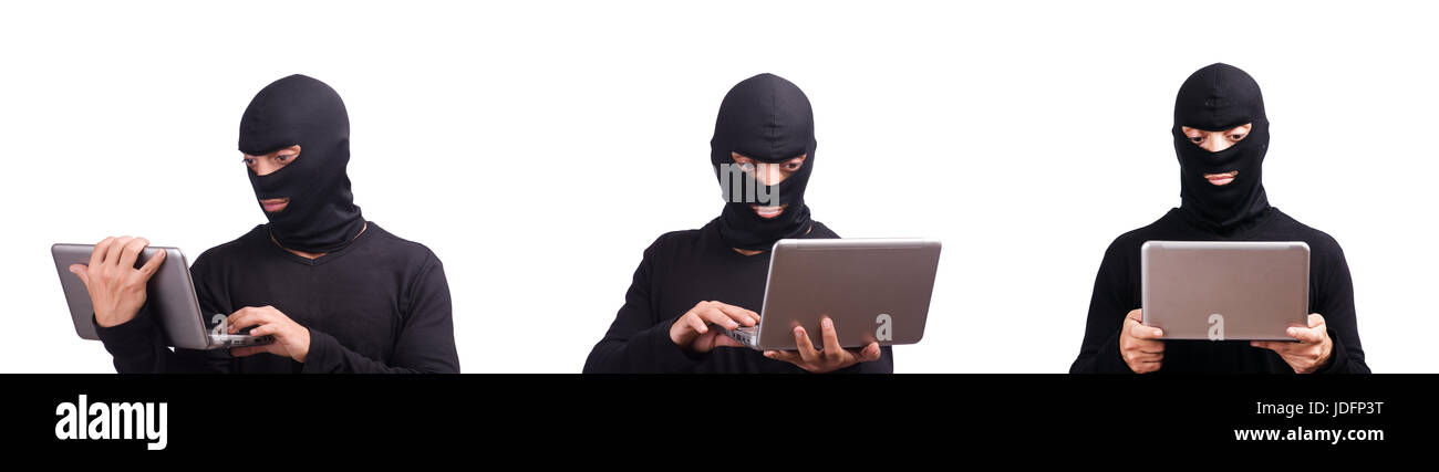 Hacker with computer wearing balaclava Stock Photo - Alamy