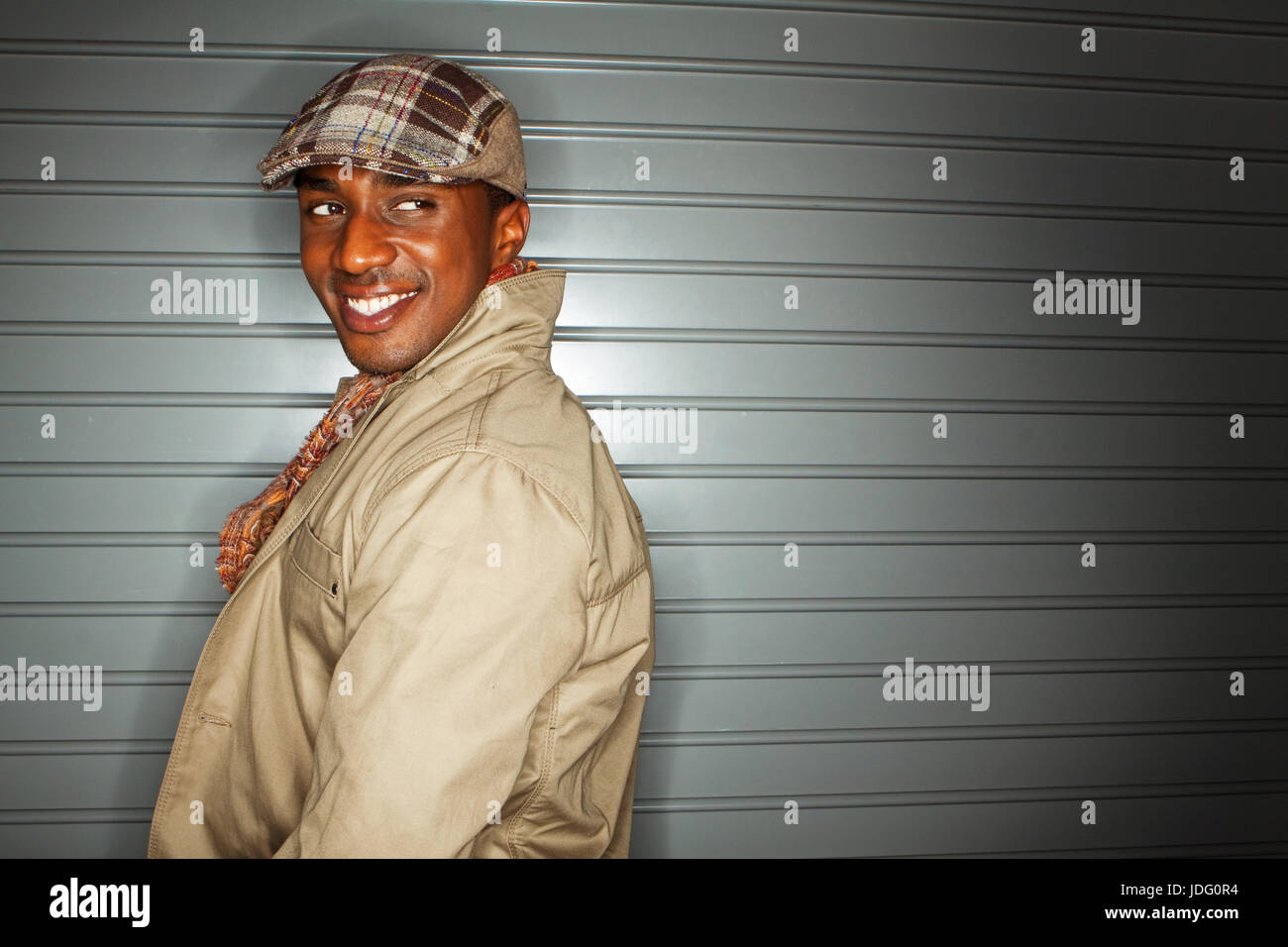 Happy fashionable young man laughing. Stock Photo