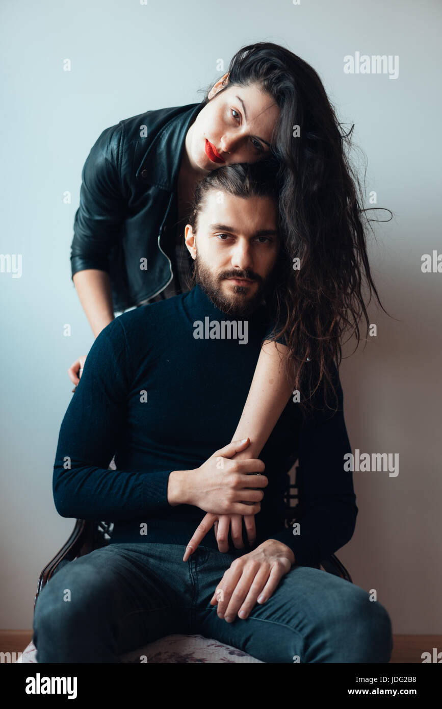Guy sitting on a chair, girl standing behind him Stock Photo Alamy