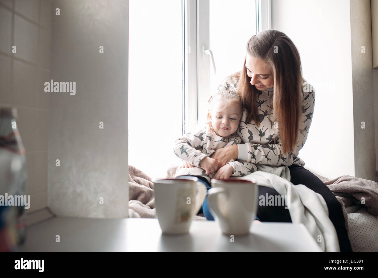 Mother and her daughter girl play in kids room Stock Photo