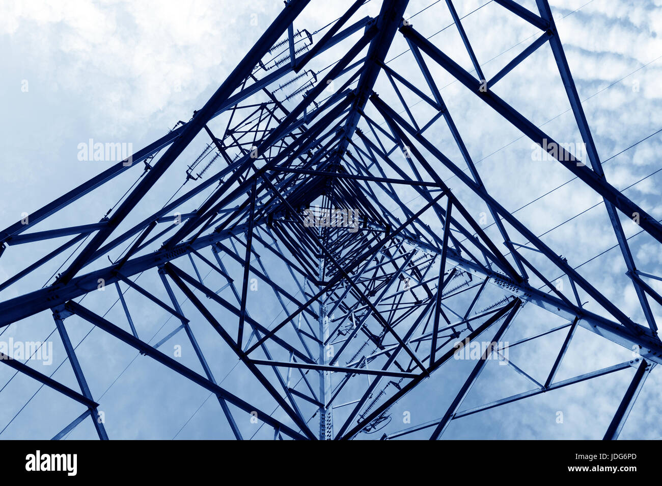 Electricity pylon against blue cloudy sky Stock Photo - Alamy