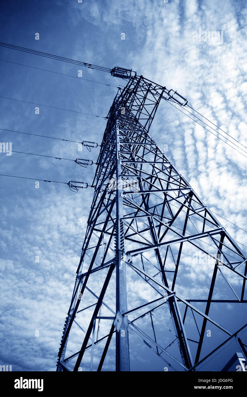 Electricity pylon against blue cloudy sky Stock Photo - Alamy