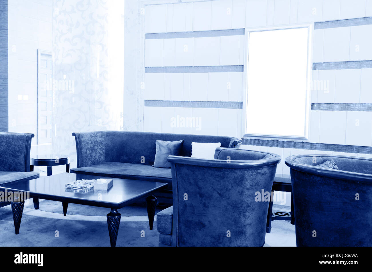 A modern living room with table, sofa and armchair Stock Photo - Alamy