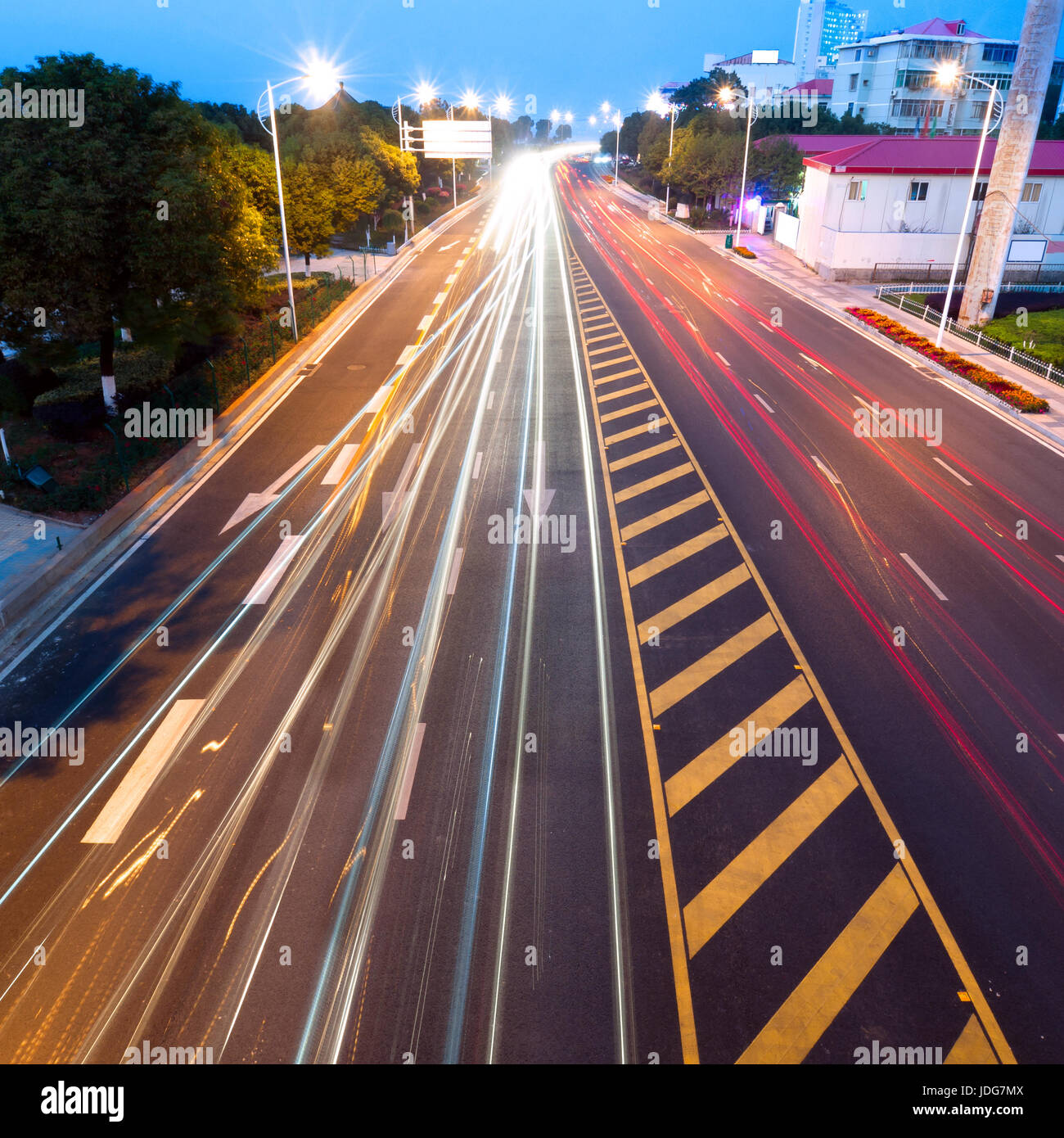 Highway light trails, modern city at night Stock Photo - Alamy