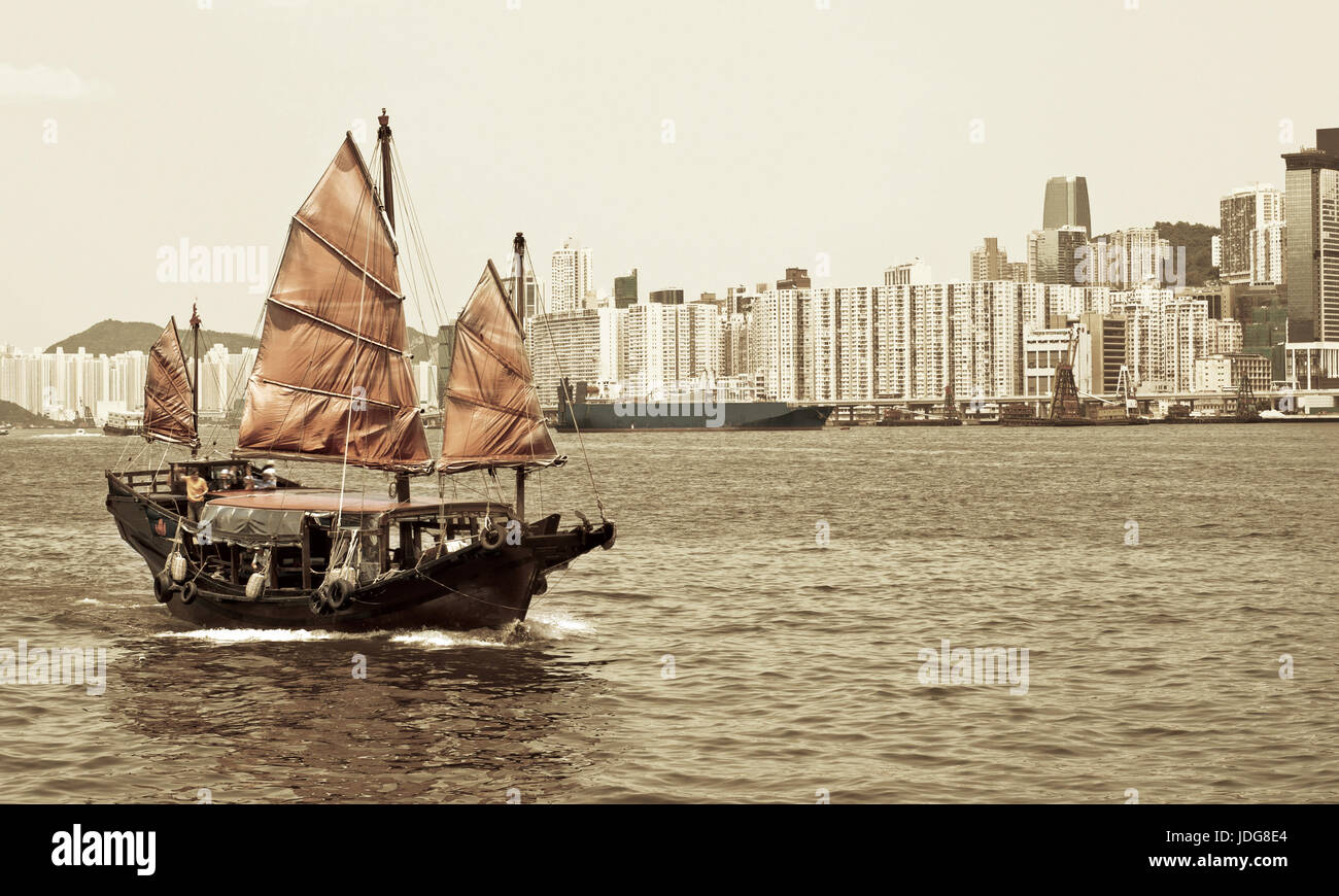Junk boat with tourists in Hong Kong Victoria Harbour Stock Photo