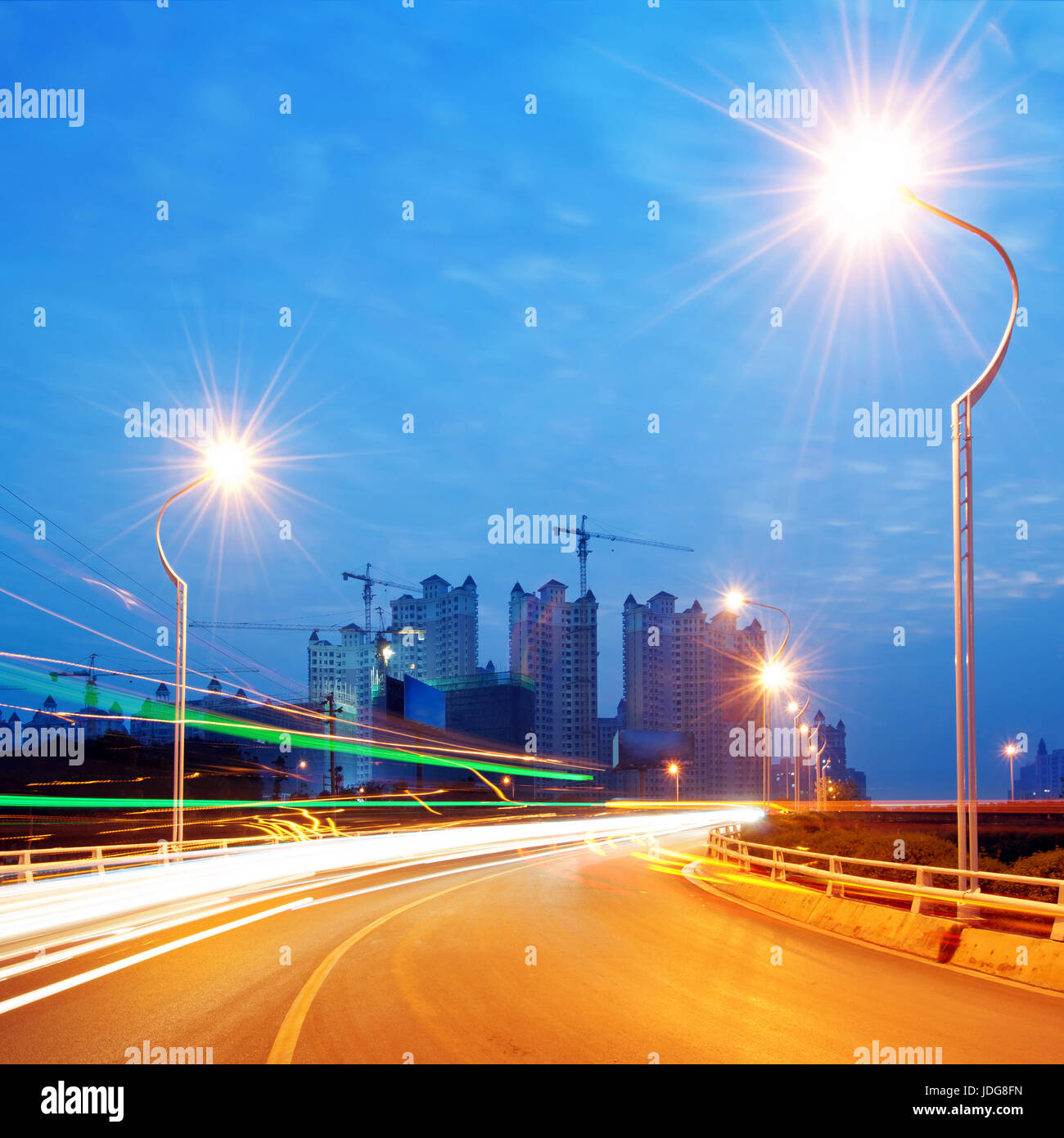 Highway light trails, modern city at night Stock Photo Alamy