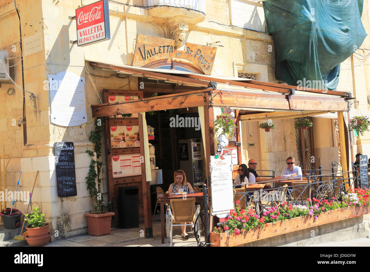 Small street cafe people sitting tables outside, Valletta, Malta Stock