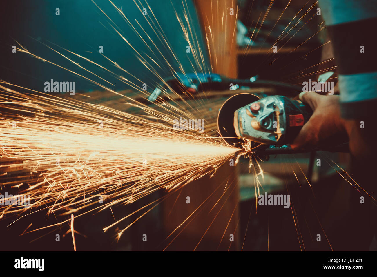 Sparks during cutting of metal angle grinder. Close-up saw sawing a steel. Soft focus. Shallow DOF. Stock Photo