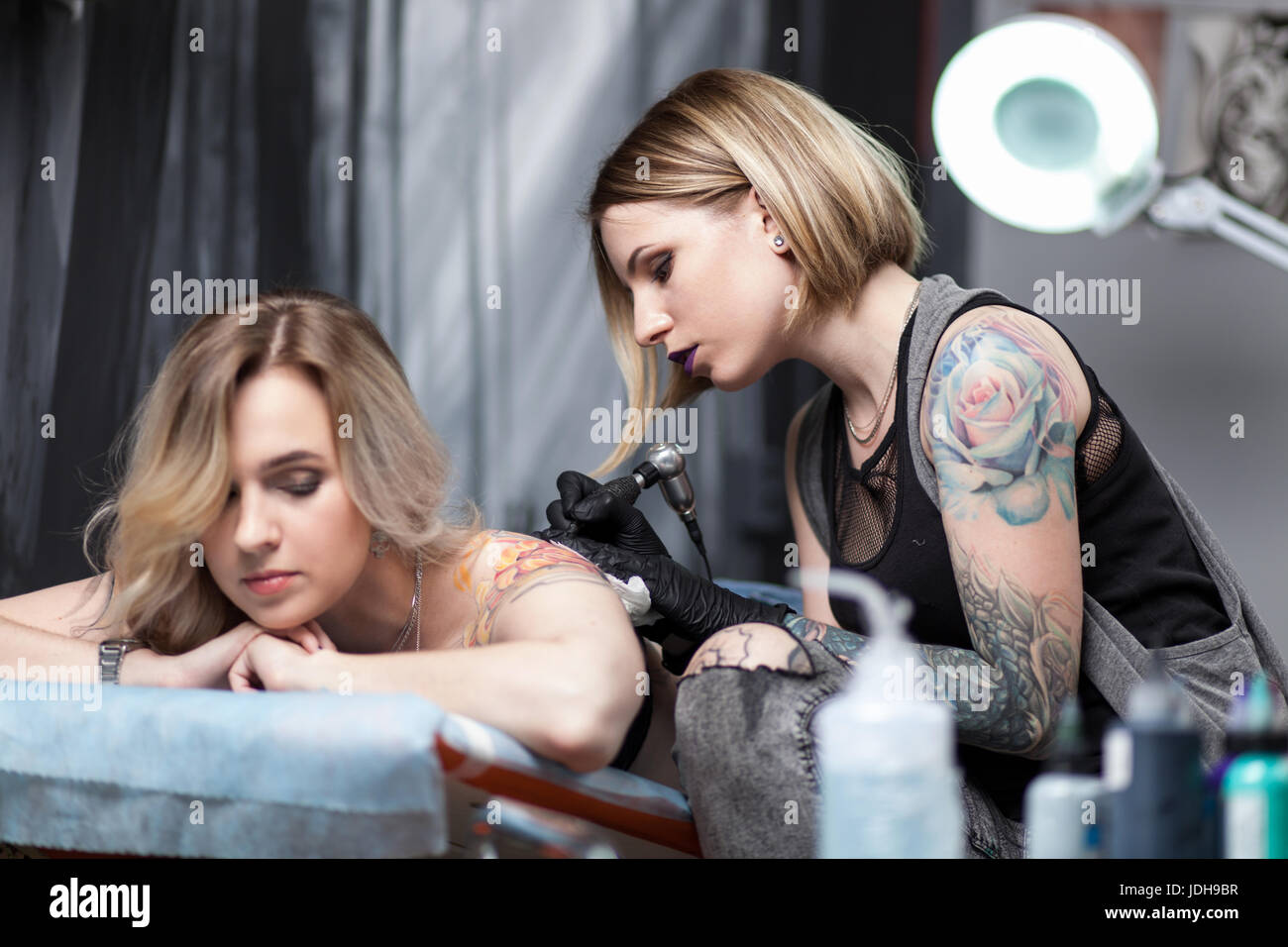 Tattoo artist in a studio Stock Photo