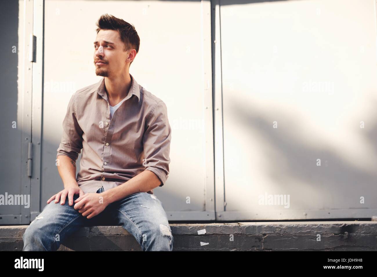 Handsome man outdoors portrait in the city. Warm colors Stock Photo - Alamy